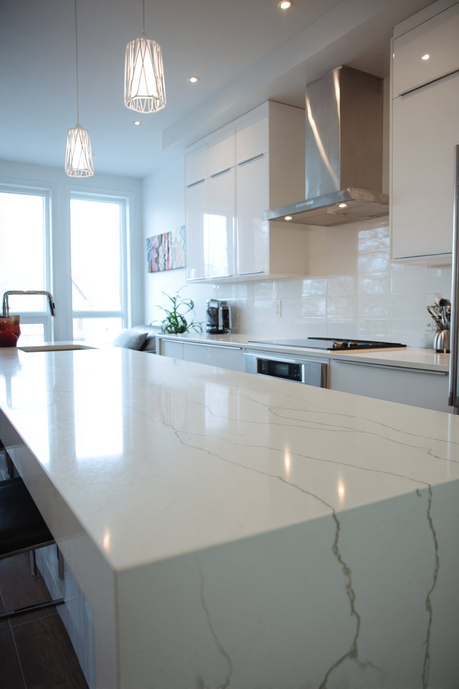 Sleek Handleless White Cabinetry with Waterfall Quartz